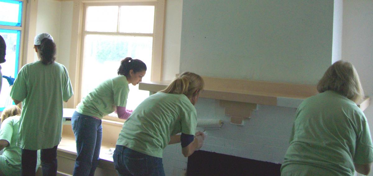 Volunteers help paint a house